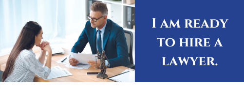 Man and Woman sitting at a table - Click here if you are ready to Hire A Lawyer.